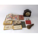 A small collection of stamps, bakelite mantle clock, stereoscopic cards, etc