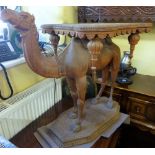 A fine example of an Indian hardwood camel table, the camel supporting square cut top with turret