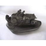 Novelty cast resin Standish in the form of two gentlemen racing in a classic car, the bonnet hinge