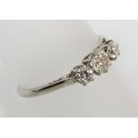 A platinum and diamond three stone ring set with brilliant cut diamonds, central stone 0.25 cts,