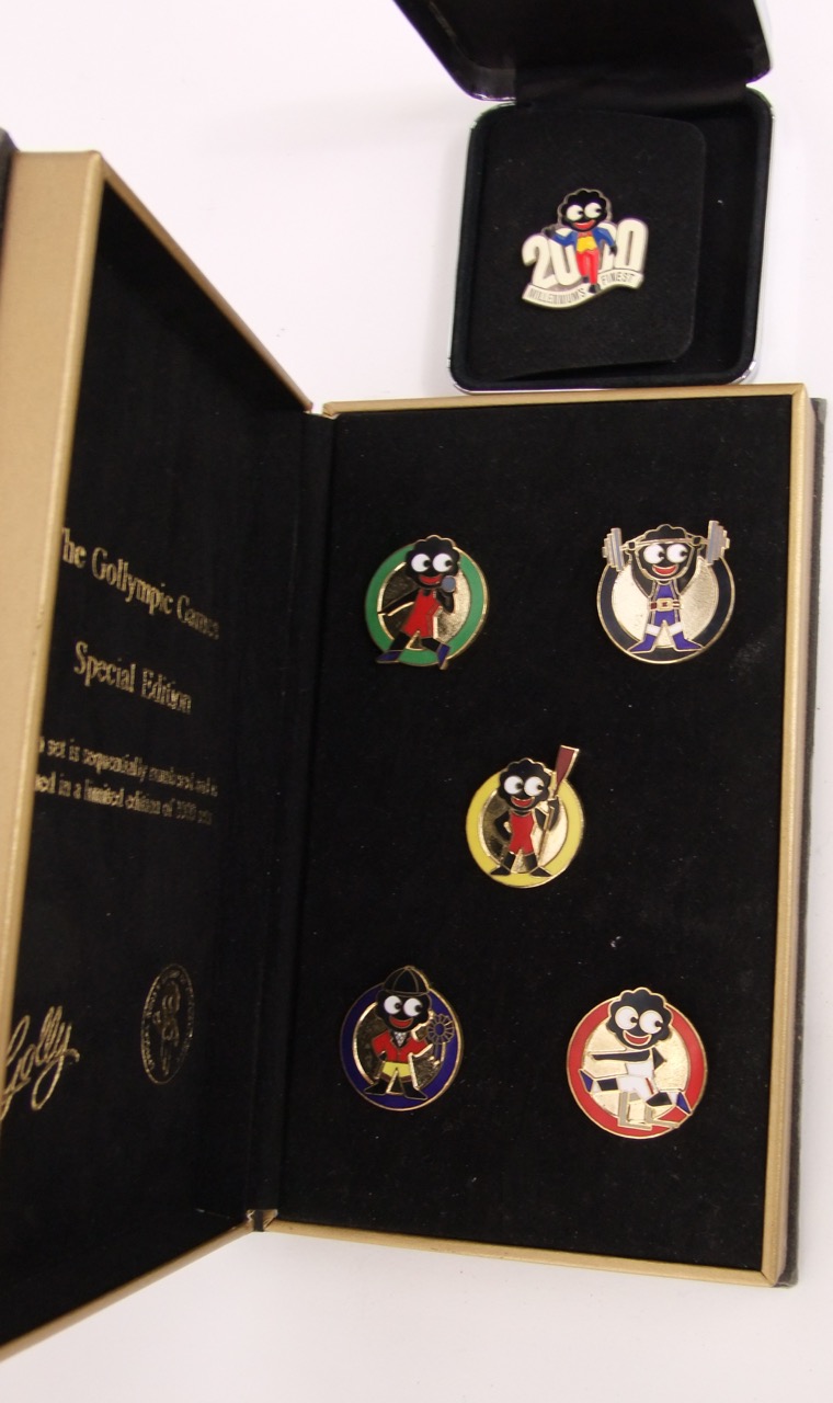 The Golympic Games cased set of five enamel badges 159/2,000 together with a Millennium Golly