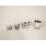 Three sterling silver mustard pots, two with pierced decoration and blue glass liners together