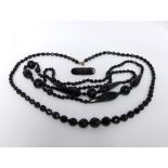 Three pieces of late Victorian black jewellery to include two necklaces and a small brooch