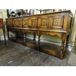 A good quality Jacobean style oak pot board dresser enclosing four frieze drawers each disguised