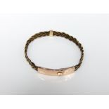 An early 20th century unmarked precious yellow metal and elephant hair bracelet