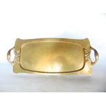 Arts and Crafts planished brass twin handled tray in the manner of Archibald Knox, 65 cm long