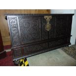 A 17th century style blanket chest with rising lid, the front elevation with geometric carved detail