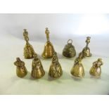 A collection of novelty brass hand bells to include two with handles in the form of Nelson, ladies