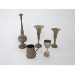 A collection of Indian white metal items to include a large ornate spice shaker, two trumpet vases