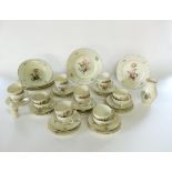 A collection of Royal Copenhagen tea, dinner and other wares with floral sprigs on a cream