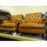 A pair of modern tan leather button back studded lounge chairs