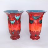 A pair of substantial Poole Pottery vases with flared necks and abstract glazed decoration in red,