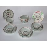 A set of four early 19th century tea bowls and saucers with painted floral sprigs and garland