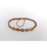 An early 20thcentury 9ct gold, black opal and seed pearl bracelet (one vacant setting), 7.5 g