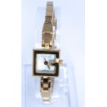 A Gucci ladies wristwatch with integral strap with gilt finish and original box