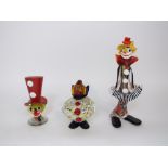 A Murano glass type figure of a standing clown playing an accordion, 13 cm tall, together with a