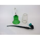 A 19th century green glass pipe, 46 cm long approximately, together with a green glass bell with and