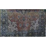 Large Kashan carpet decorated with various scrolled floral medallions upon an ivory ground, 400cm