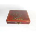 A Japanese lacquered traveling chest set with novelty pieces