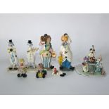 A collection of ceramic models of clowns all with shredded clay details for hair, including