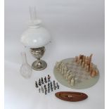 African hard stone chess cet and board with novelty pieces, together with a silver plated oil lamp