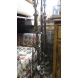 Three various brass standard lamps, one in the form of a Corinthian column, the other in the