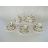 A collection of 19th century tea wares with painted floral sprigs and sprays comprising tea pot,