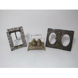 Two Indian white metal picture frames, one dual oval aperture embossed with a monkey, elephant and