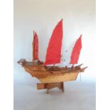 Scale carved wooden model of a Chinese junk ship upon a stand, 65 cm high