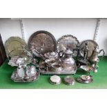 A large mixed collection of silver plated items to include tea services, candelabra, trays,