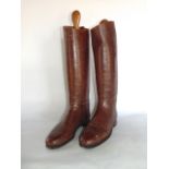 A pair of brown leather riding boots of good quality together with a three tier? Hanging towel