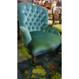 A Victorian style button back bedroom chair with blue upholstery and turned front legs