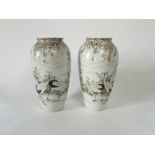 A pair of late 19th century oriental vases with polychrome painted stork and blossom decoration with