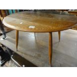 An Ercol Golden Dawn elm circular coffee table, 46 cm high x 76 cm diameter approx