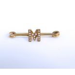 A Victorian 9ct and seed pearl pin brooch with entral monogrammed M, 2g approx