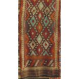 A Kelim type runner decorated with various coloured diamonds upon a maroon ground, 247cm x 76cm