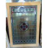 A Victorian leaded light panel with gothic quatrefoil centre within a green and red stepped