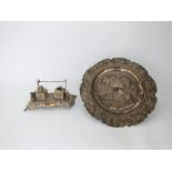 An Indian white metal standish with chased and pierced decoration flanked by two ornate horses,