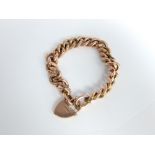 A 9ct gold curb link chain bracelet set with 9ct heart locket 19.4 gram