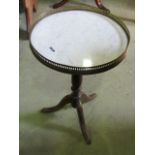 A small tripod table with circular marble top and pierced brass gallery