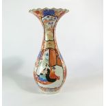 A 19th century Imari vase with flared and crimped neck and painted male and female character