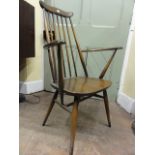 A pair of Ercol dark elm Goldsmith carver chairs