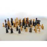 A box containing a selection of various chess pieces in the manner of Staunton & Calvert