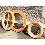 Three stripped pine casement window frames of circular form, two 3ft in diameter, the other 2ft