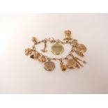 A 9ct gold charm bracelet set with numerous 9ct and 15ct gold charms, 38.2g