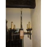 A hanging ceiling light, the central chamfered oak block supporting four ironwork branches