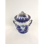 A 19th century blue and white printed flow blue type two handled crock and cover with floral and