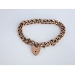 A 9ct gold curb link bracelet with 9ct heart locket, 12 g