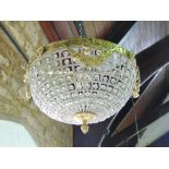 A pair of domed gilt metal and crystal drop ceiling lights.