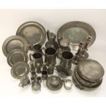 A collection of pewter items to include tankards, steins, candlesticks, plates, etc